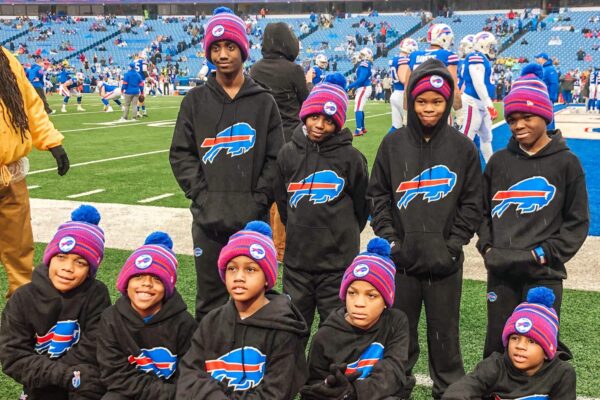 Group of young boys in Bills gear posing for photo at New Era Field