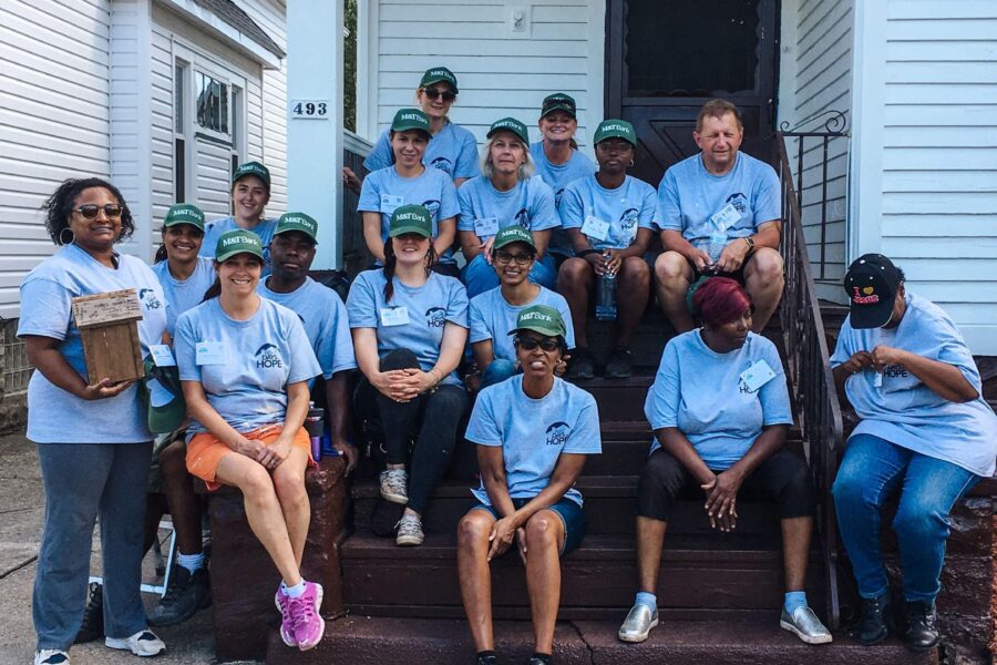Group of volunteers sitting on steps after completing a project