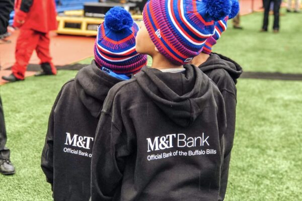 Young students on the sidelines in Bills gear at New Era Field