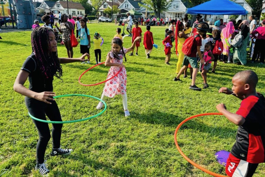 Back to school bash with families at the park and kids playing hula hoop