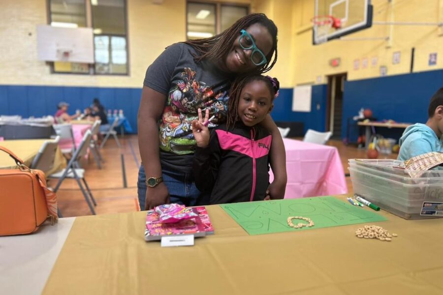 Parent and child at Westerminster's school gym making signs