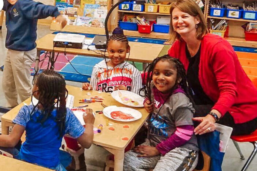 Teacher taking photo with students doing arts and crafts